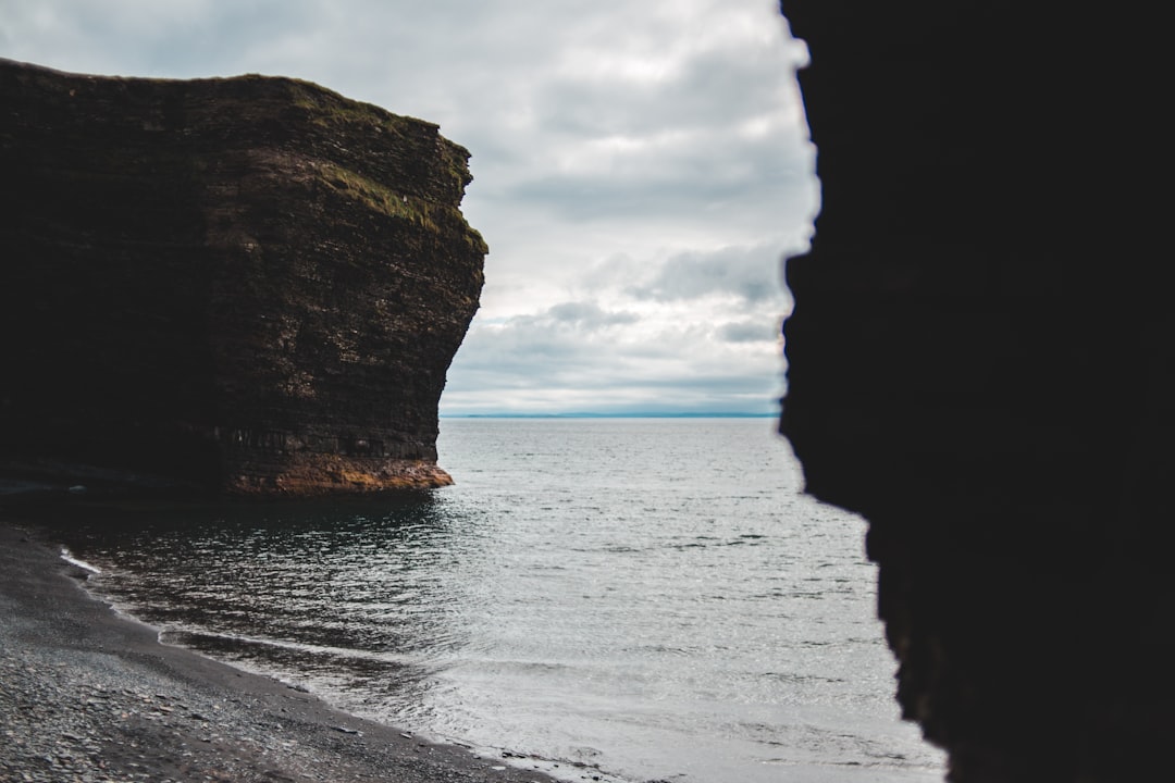 brown rock formation on sea shore during daytime