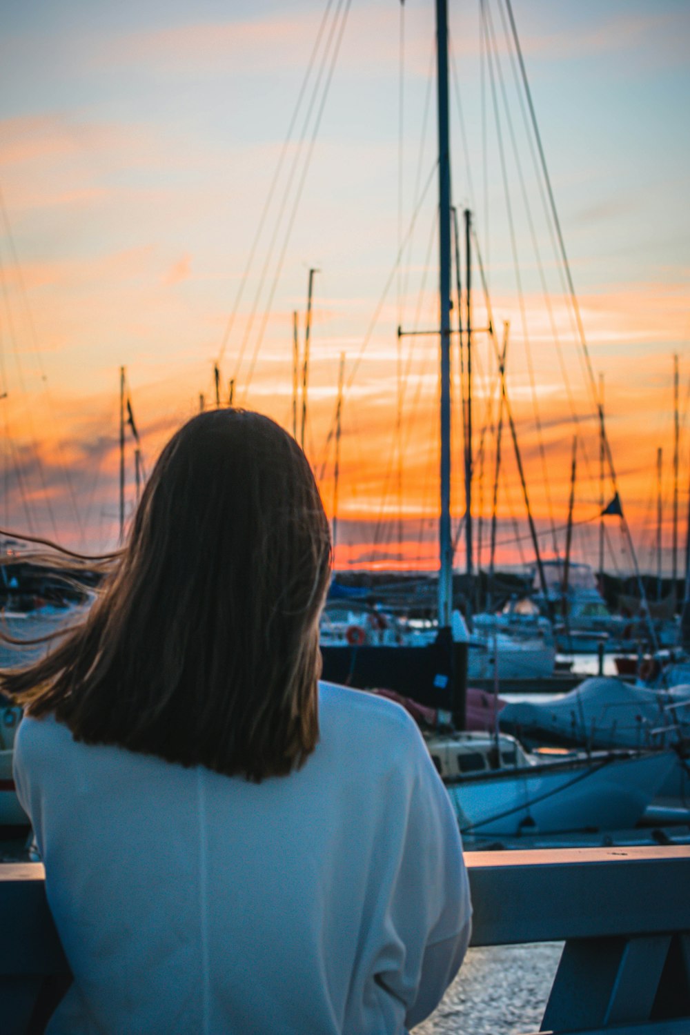 woman in white shirt standing near body of water during daytime