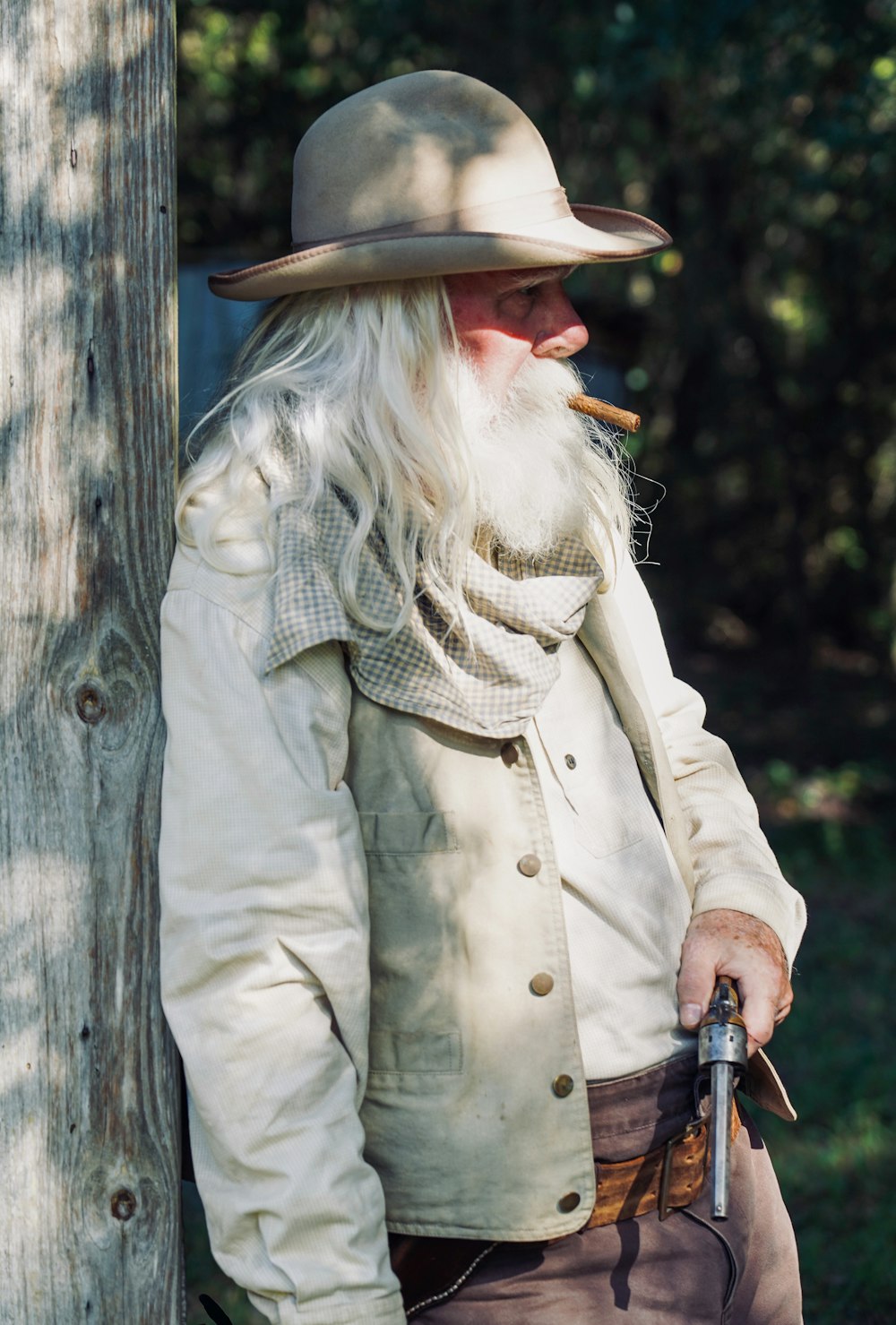 woman in white coat and brown cowboy hat holding black dslr camera