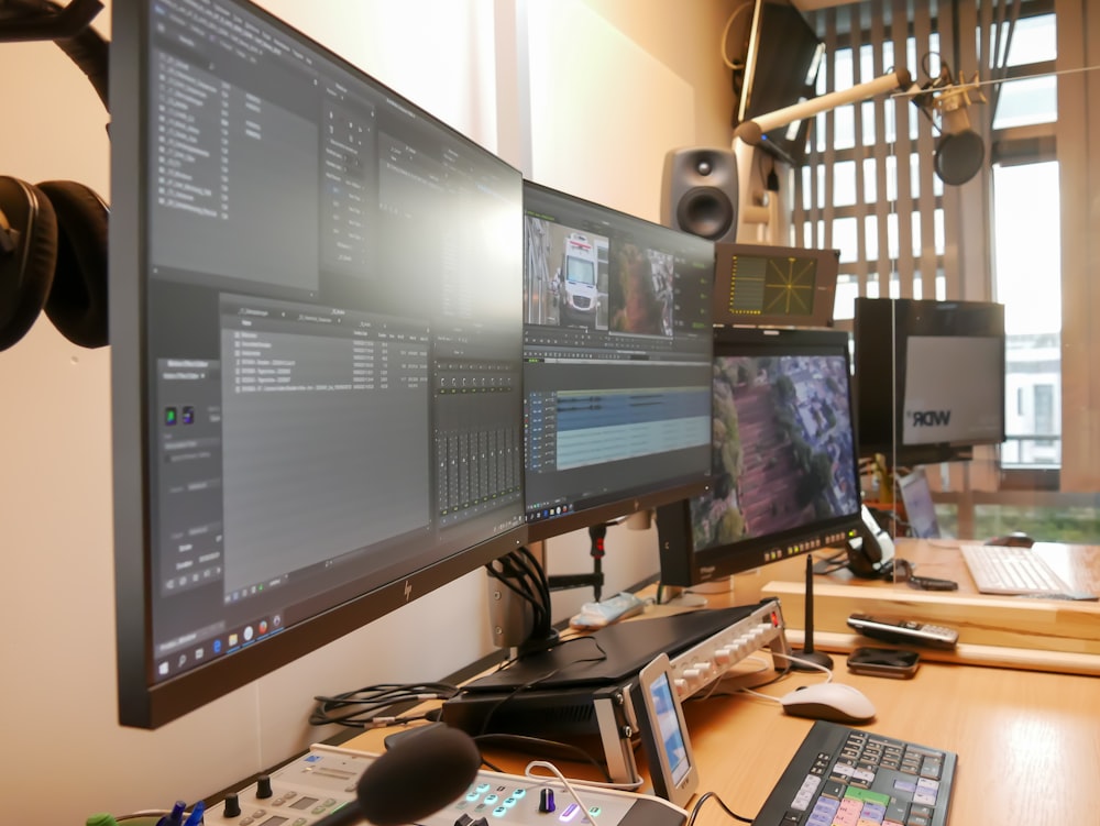 black flat screen computer monitor on brown wooden desk