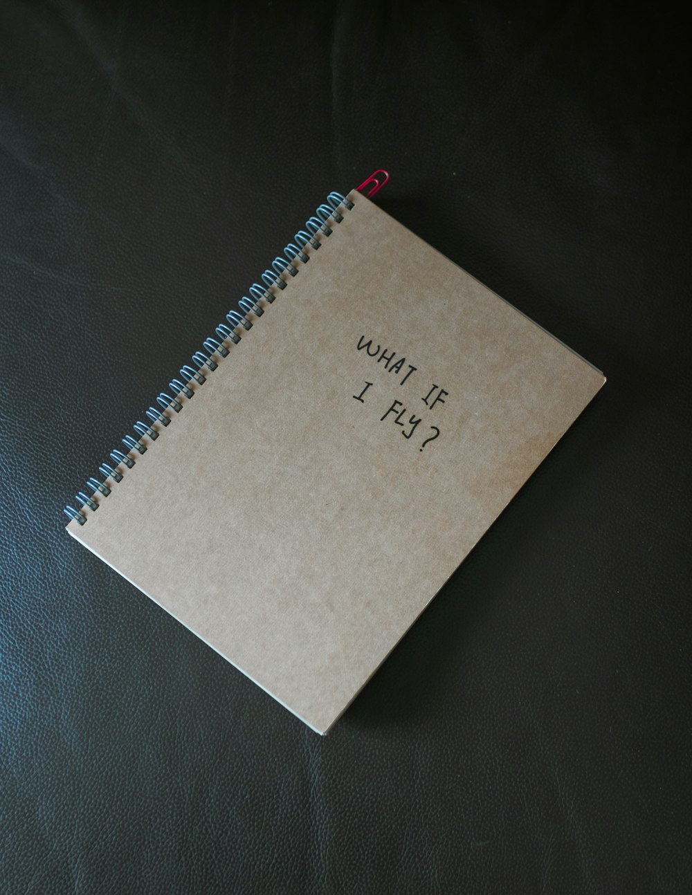 white notebook on black textile