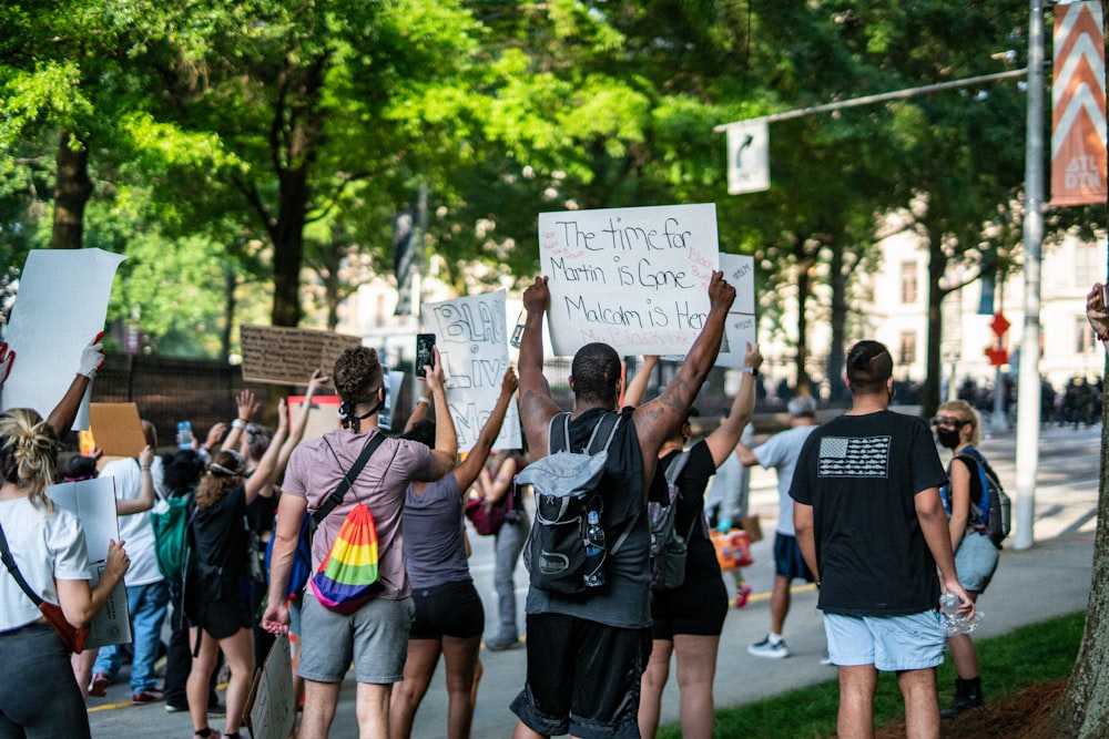 people holding white printer paper during daytime