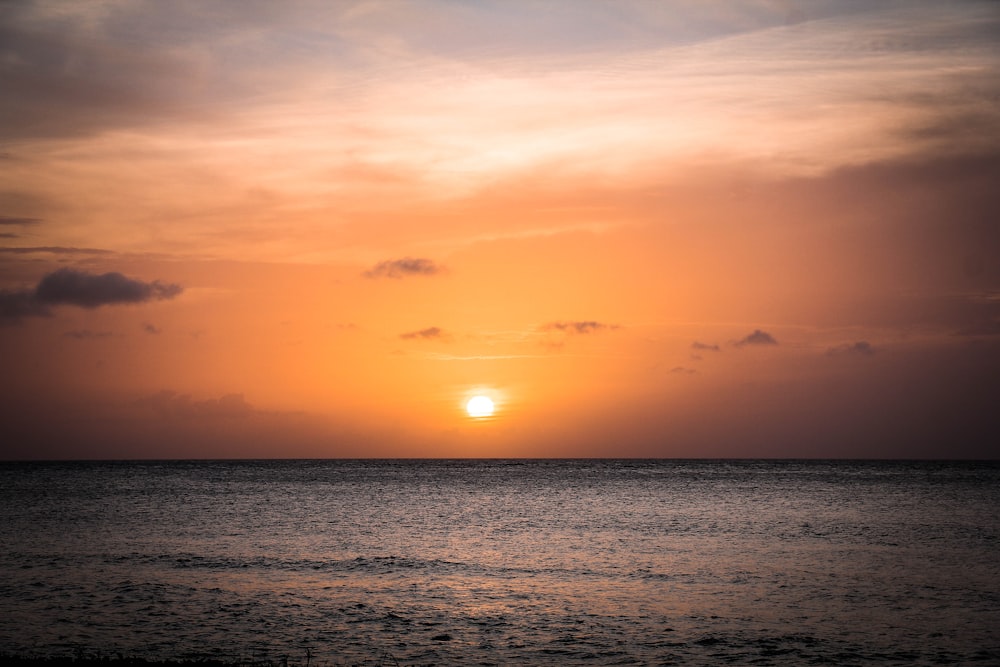 body of water during sunset