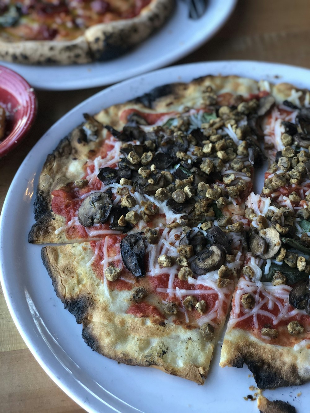 pizza with red and white sauce on white ceramic plate