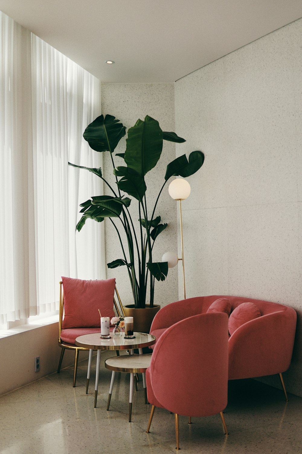 red leather sofa chair beside green indoor plant