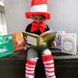 girl in red hat holding book