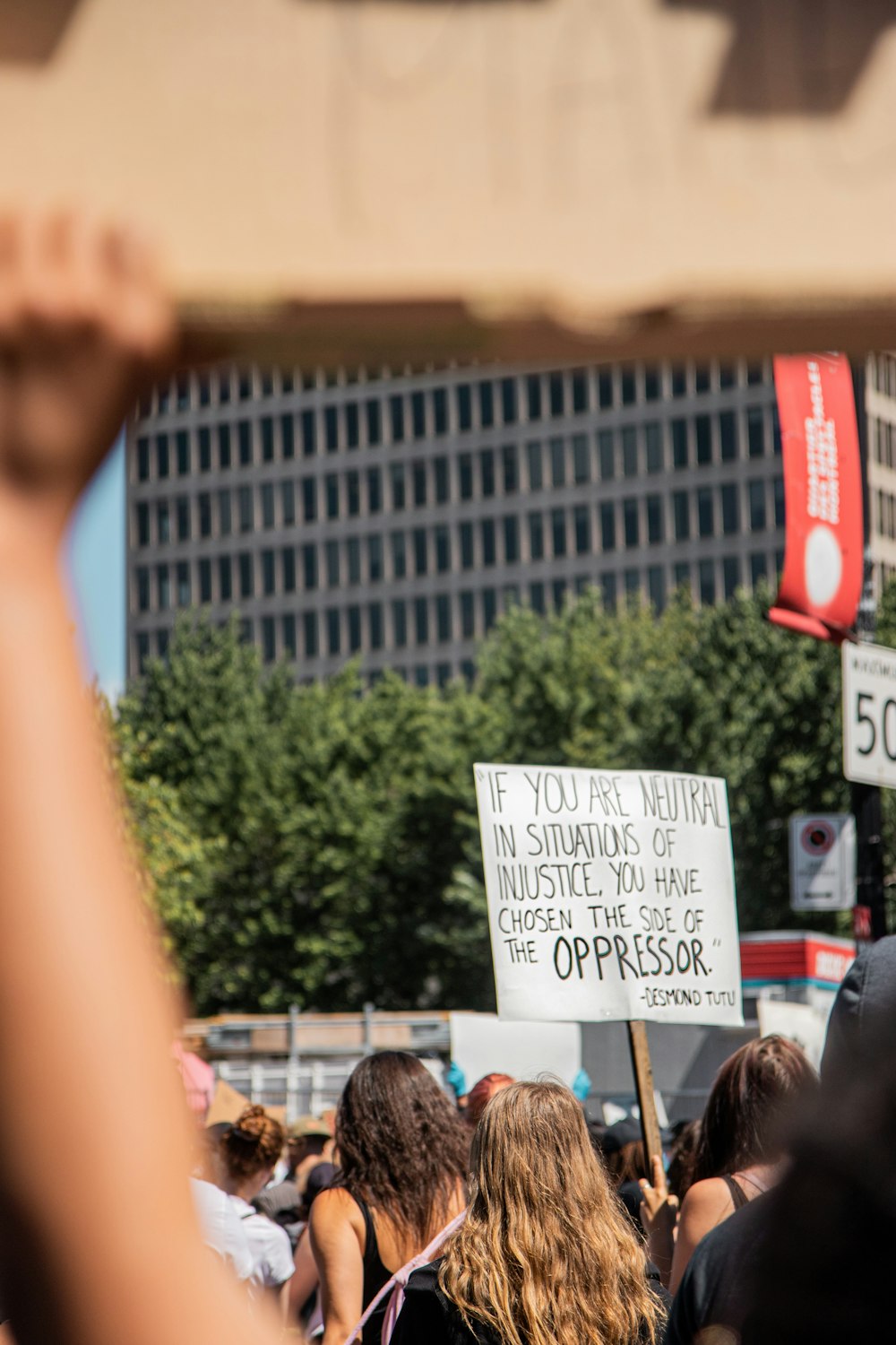 woman holding white and red signage