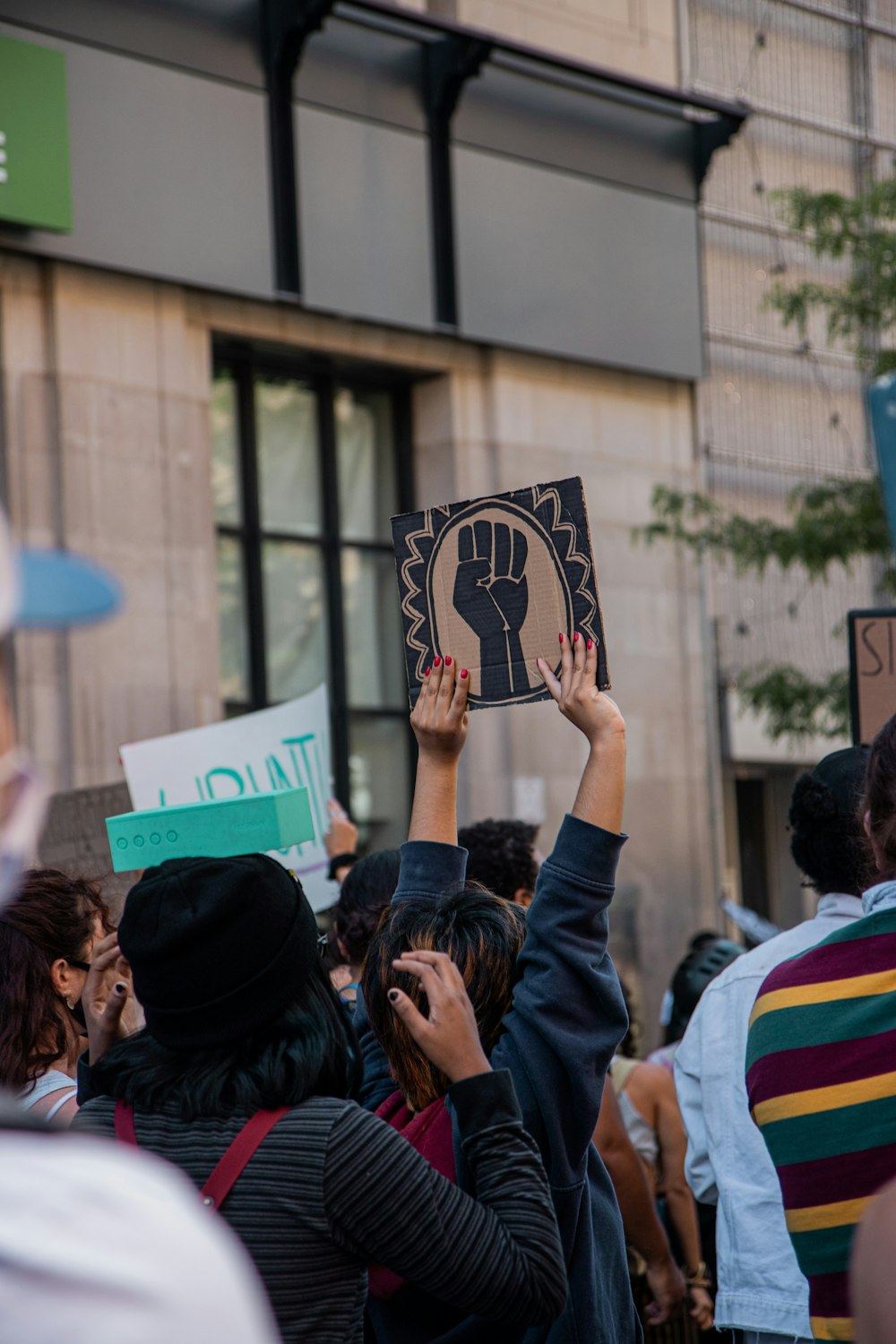 people holding white and black banner during daytime