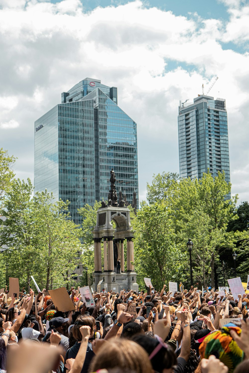 people sitting on chairs near high rise buildings during daytime