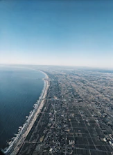 aerial view of city near body of water during daytime