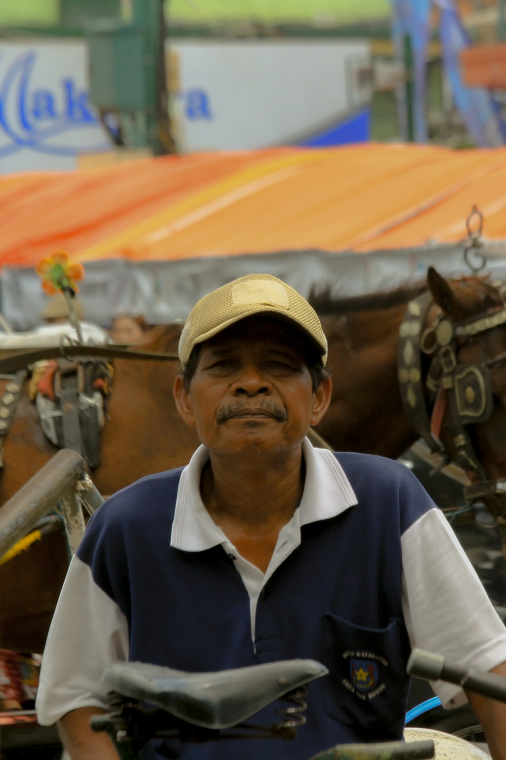 a man sitting on a motorcycle with a horse behind him