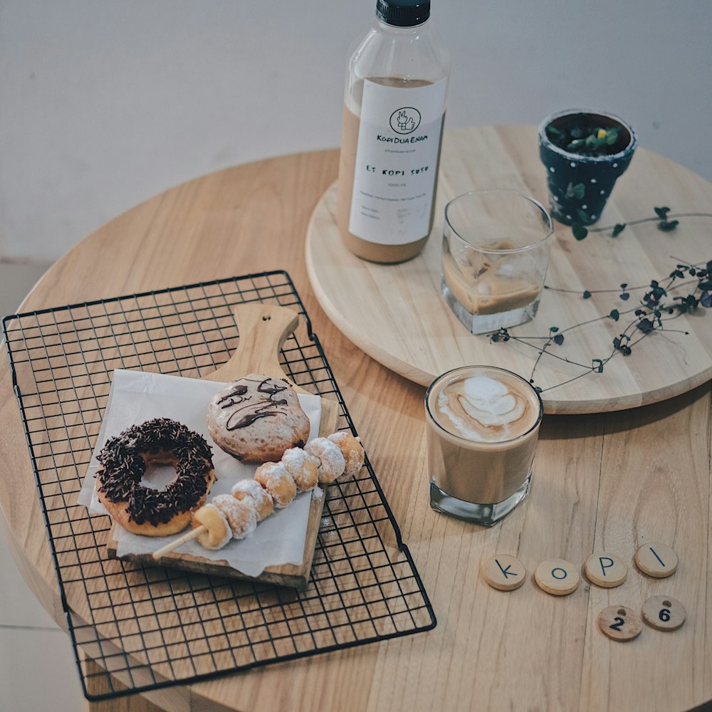 cookies on brown wooden chopping board beside clear drinking glass