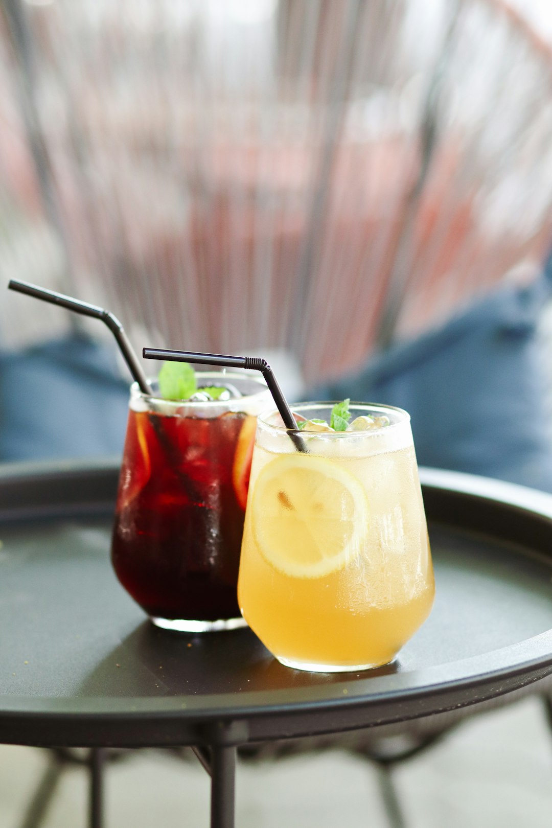 two clear drinking glasses with yellow liquid