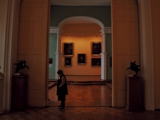 An exclusive after-hours gallery viewing with a single visitor admiring a rare masterpiece.
