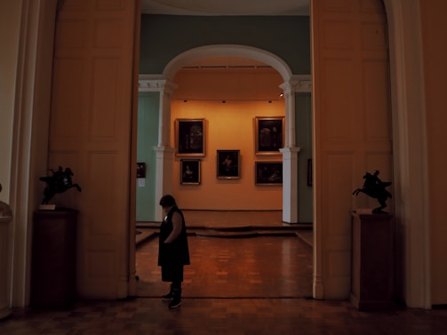 An exclusive after-hours gallery viewing with a single visitor admiring a rare masterpiece.
