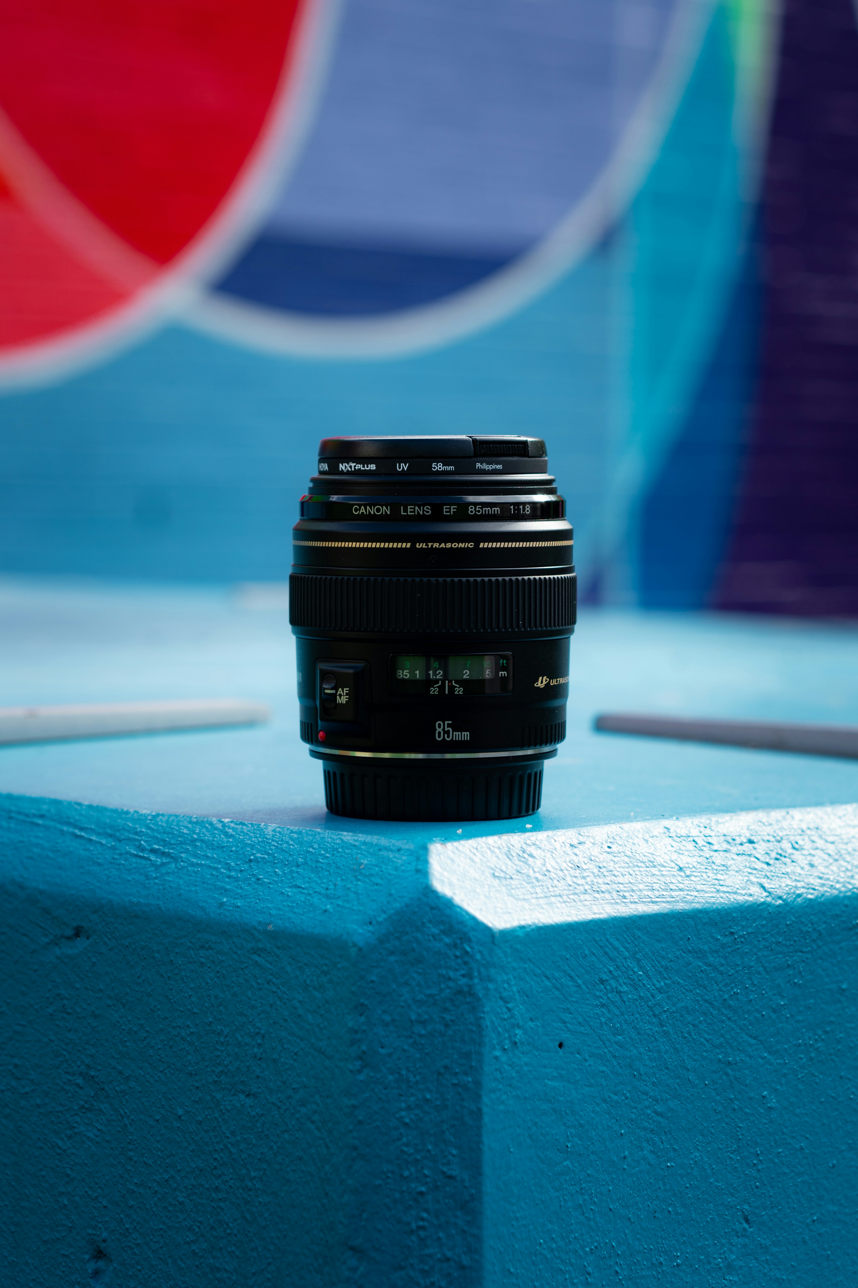 black camera lens on white and blue surface
