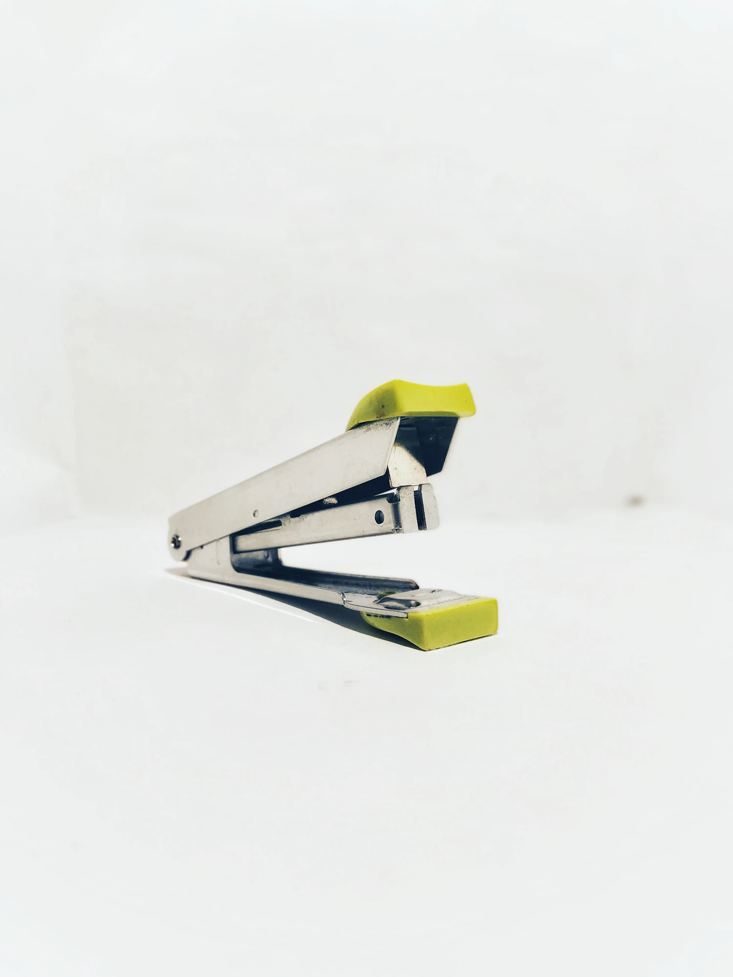 A simple stapler on a plain background, a classroom fine motor tool