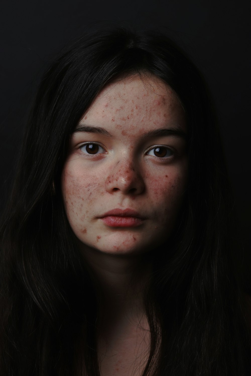 woman with black hair and pink lipstick