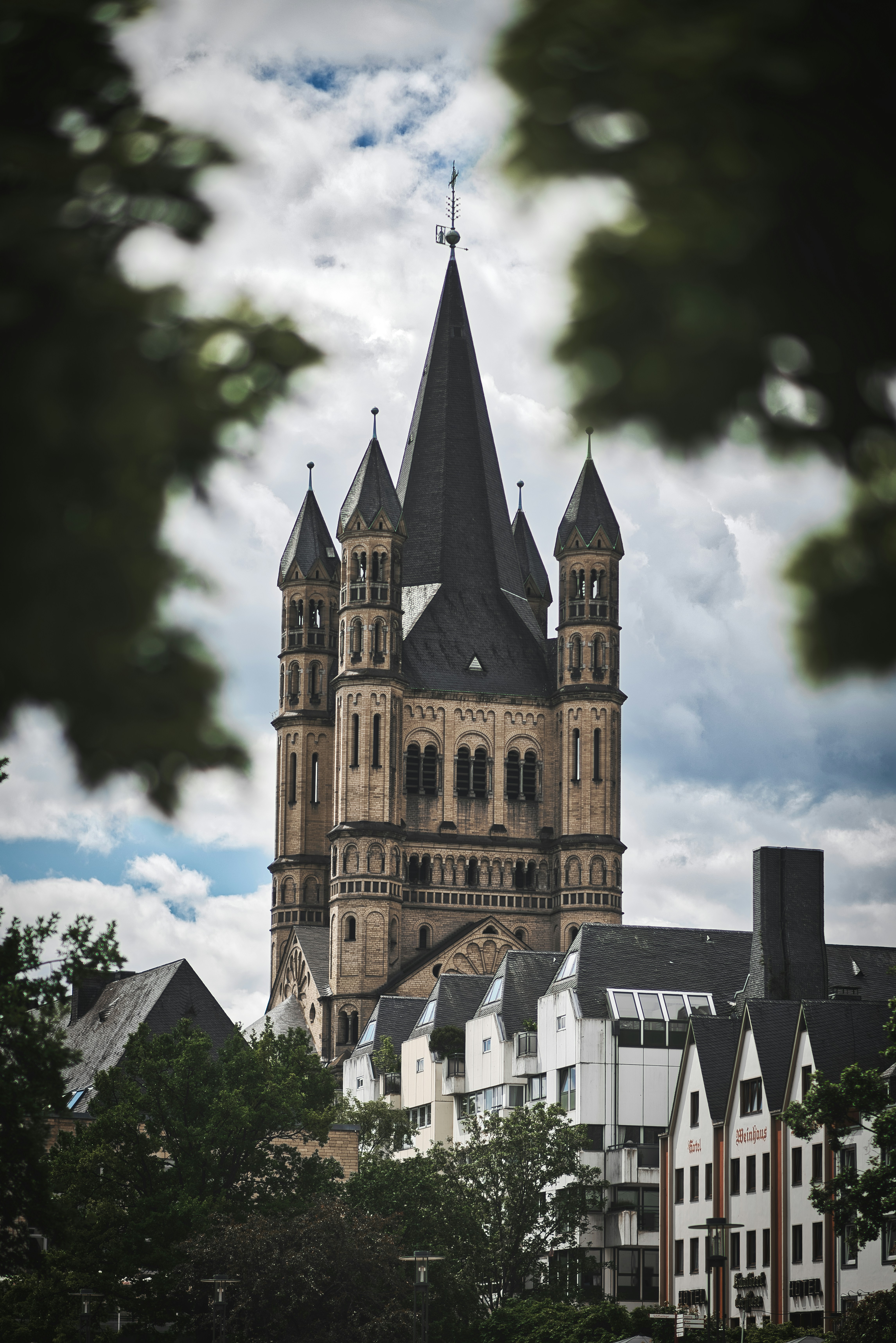brown and black concrete building under cloudy sky during daytime