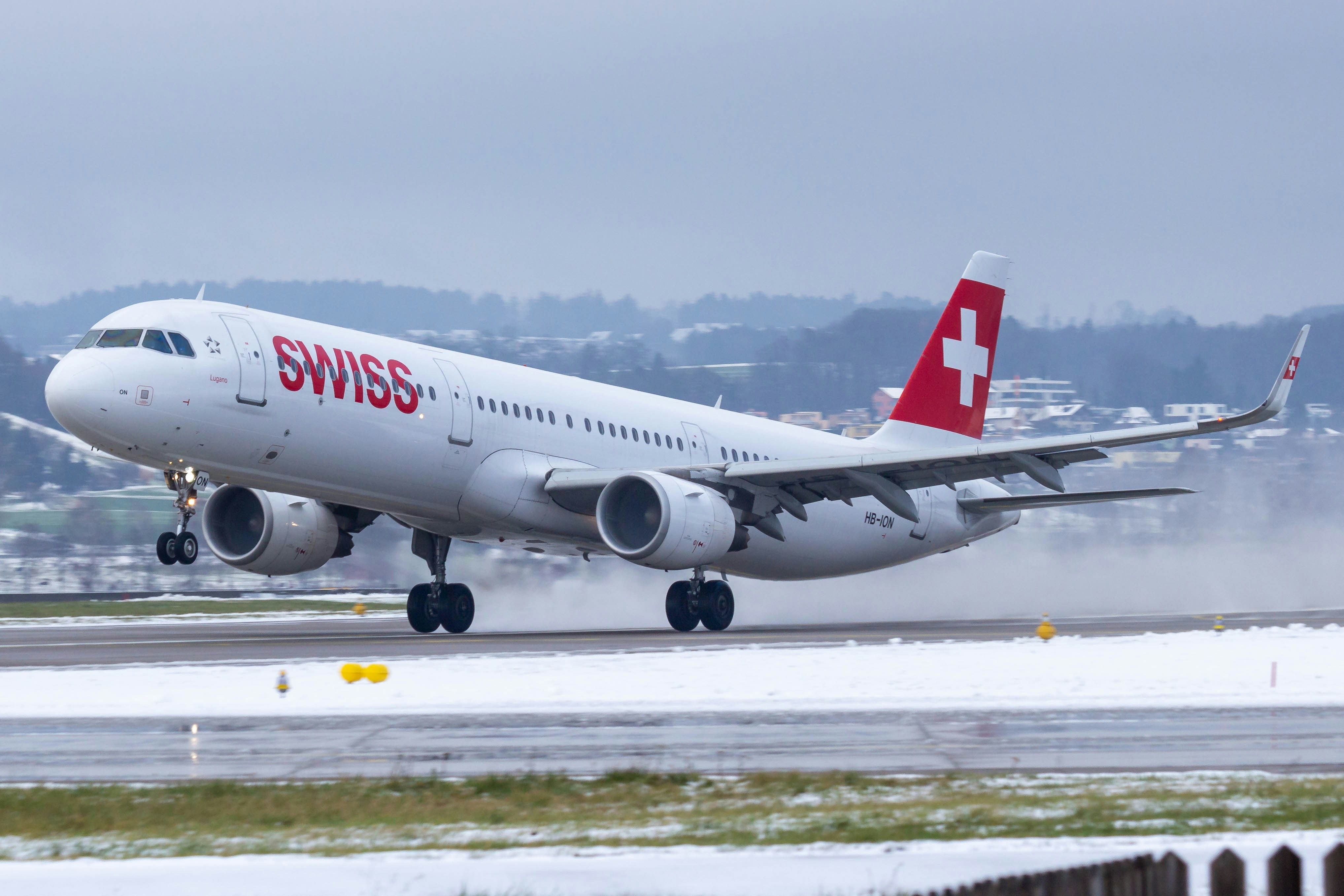 white and red passenger plane on airport during daytime, Swiss Airbus A321-200 takeoff at Zurich Airport Runway 28