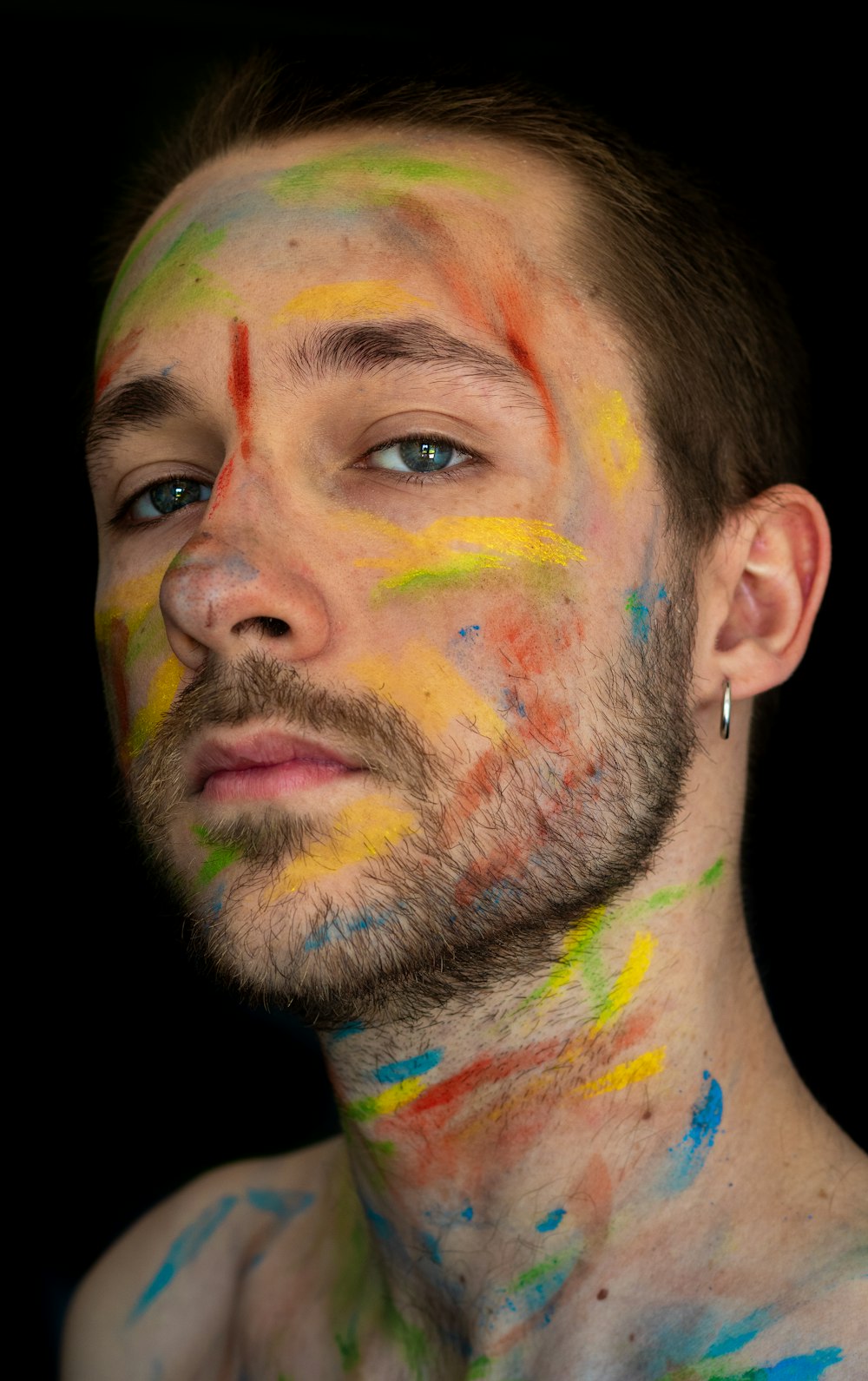 man with blue green and red paint on face