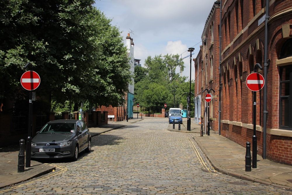 cars parked on sidewalk near buildings during daytime