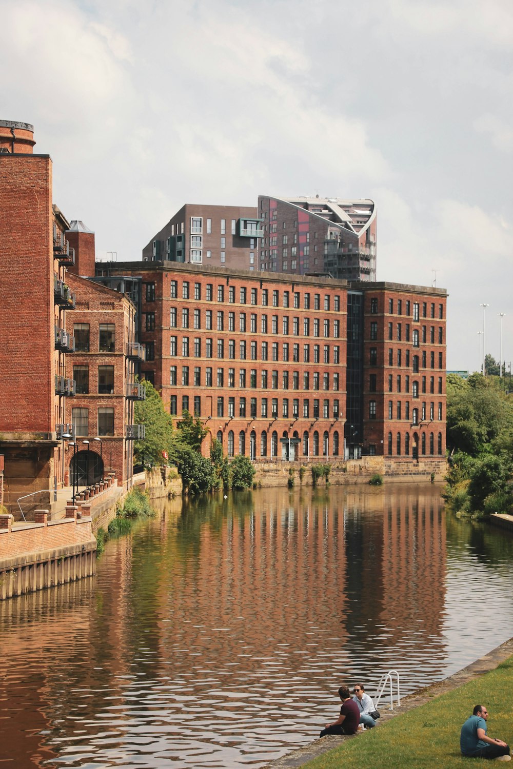 brown concrete building beside river during daytime