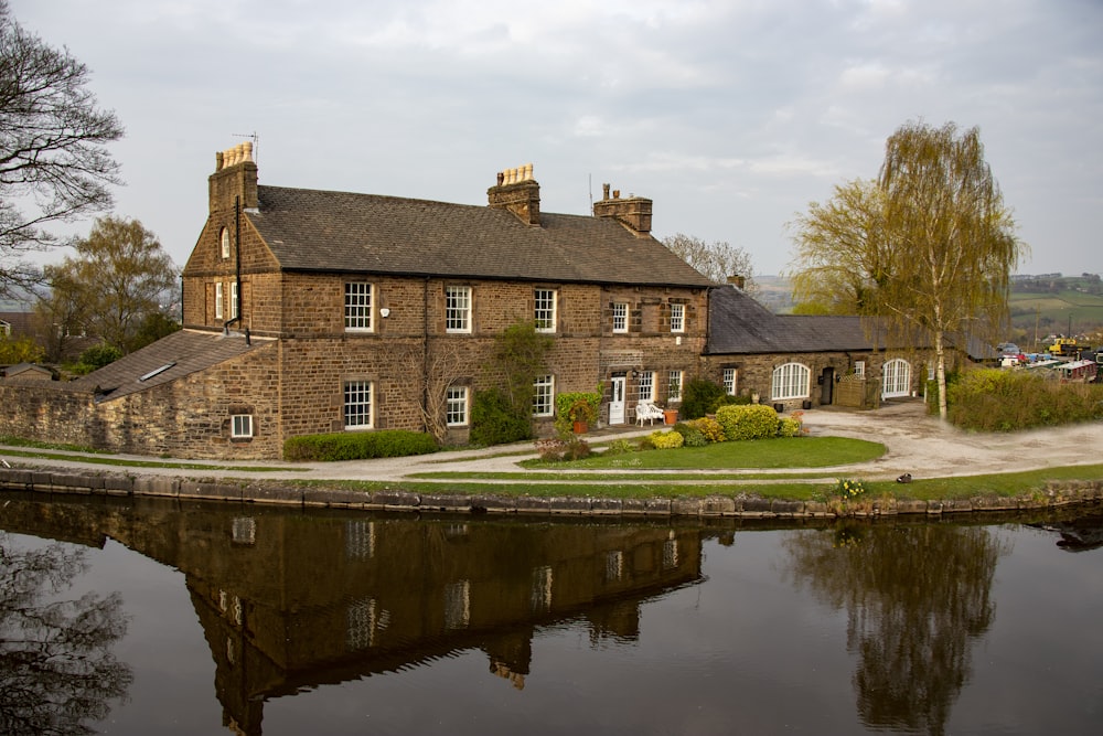 brown brick building near body of water during daytime