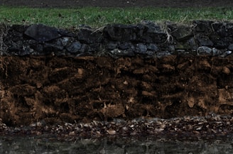 Close-up of soil layers exposed during a sondagem process.