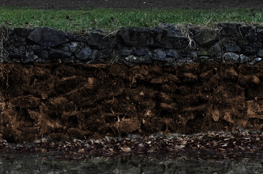 Close-up of soil layers with digital data overlay representing territorial intelligence.