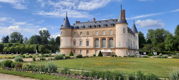 The historic Blair Castle standing proudly against a backdrop of blue sky and vibrant gardens.