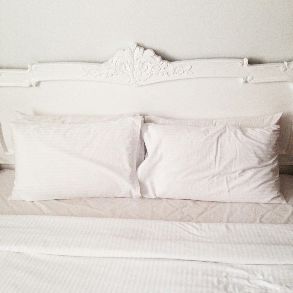 white bed pillow on bed