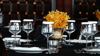 A bright dining table set with modern tableware and a centerpiece that adds a touch of elegance.