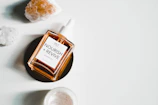 A bottle of rich hair oil surrounded by fresh botanicals, highlighting nourishment and shine.