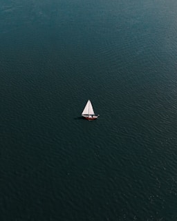 white sailboat on blue sea during daytime