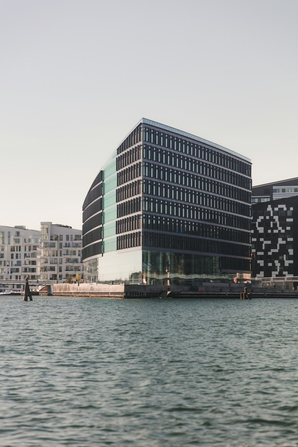 gray concrete building near body of water during daytime