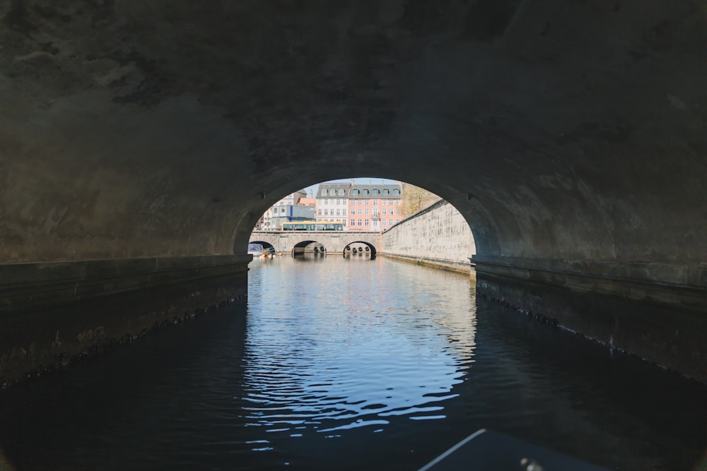 gray concrete tunnel with arch shaped tunnel
