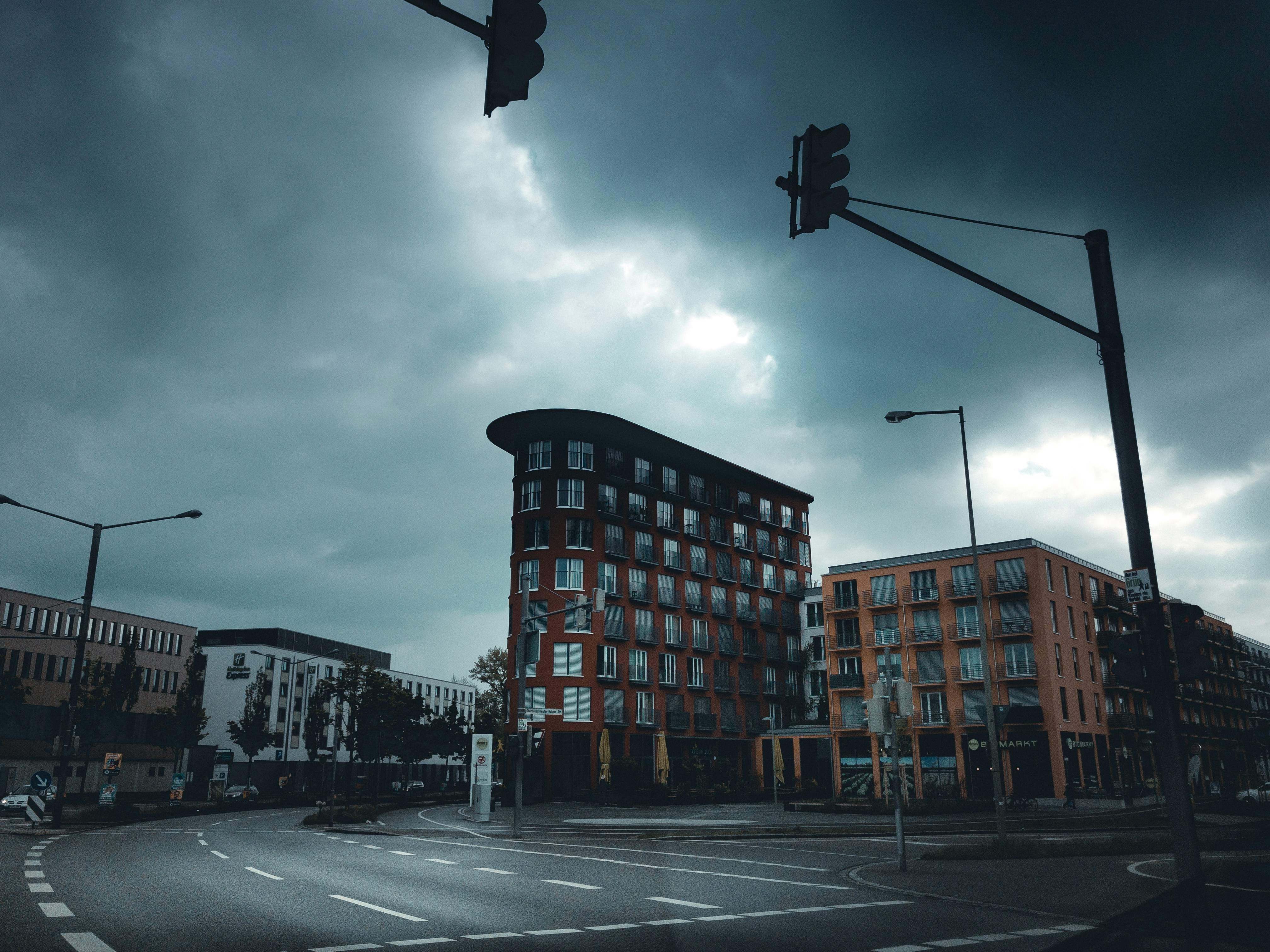Brown and black concrete building under cloudy sky during daytime