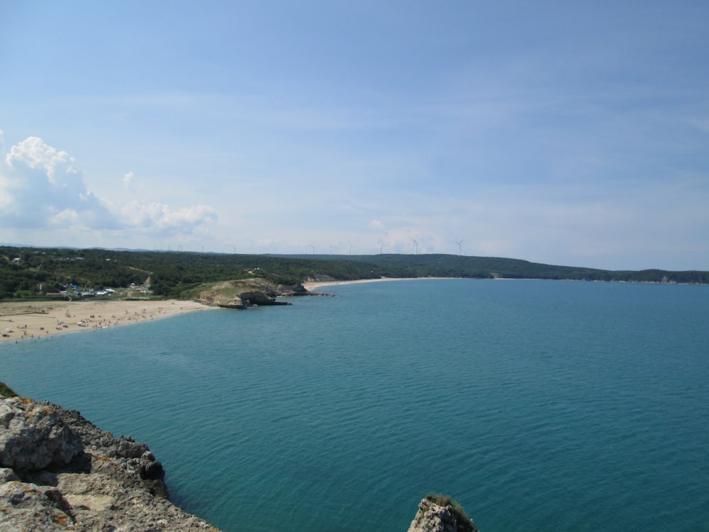 green island in the middle of blue sea under blue sky during daytime