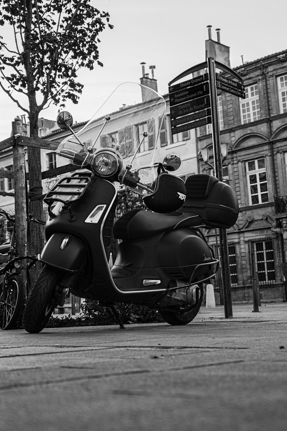 grayscale photo of motorcycle parked on street