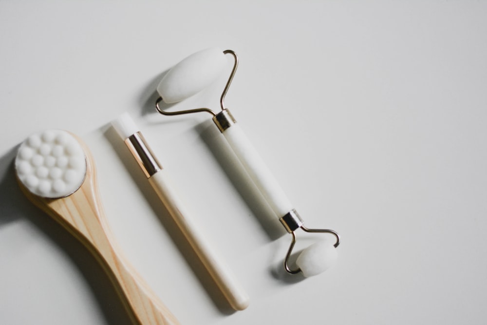 silver spoon and fork on white surface