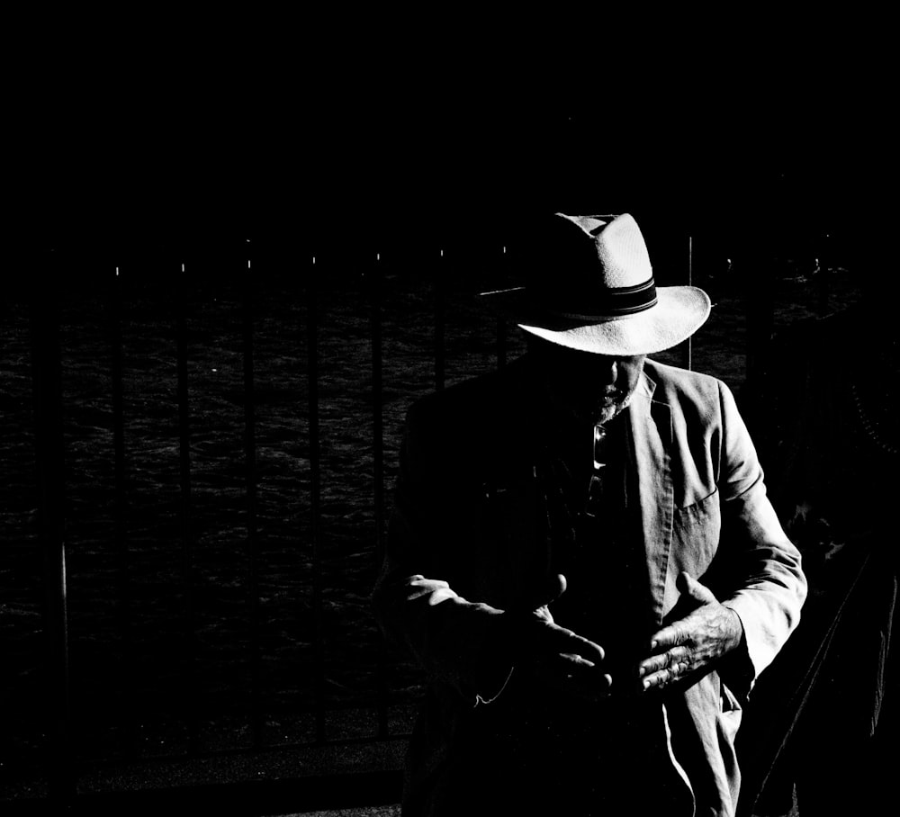 man in black suit and white cowboy hat