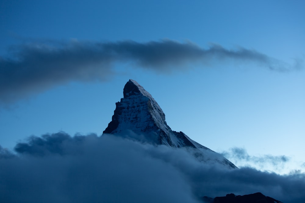 snow covered mountain under cloudy sky during daytime