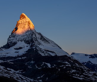 snow covered mountain under blue sky during daytime