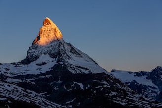 snow covered mountain under blue sky during daytime