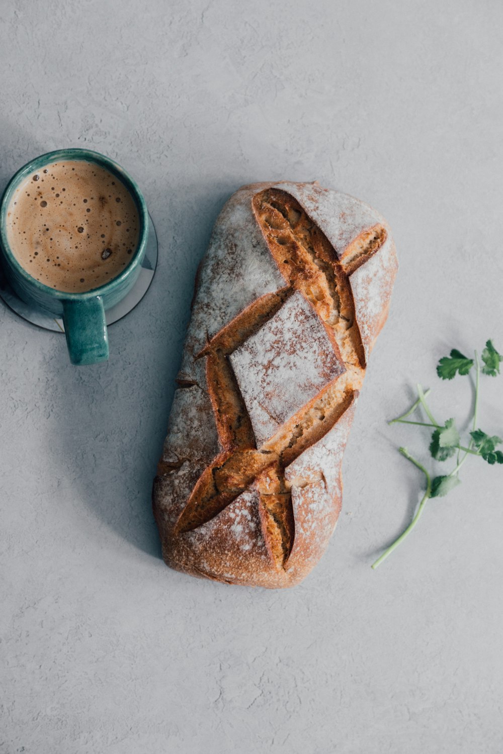 bread on bread beside green ceramic mug