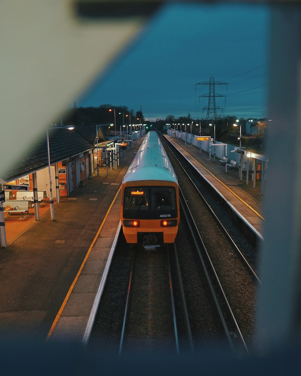 yellow and black train on rail road during daytime