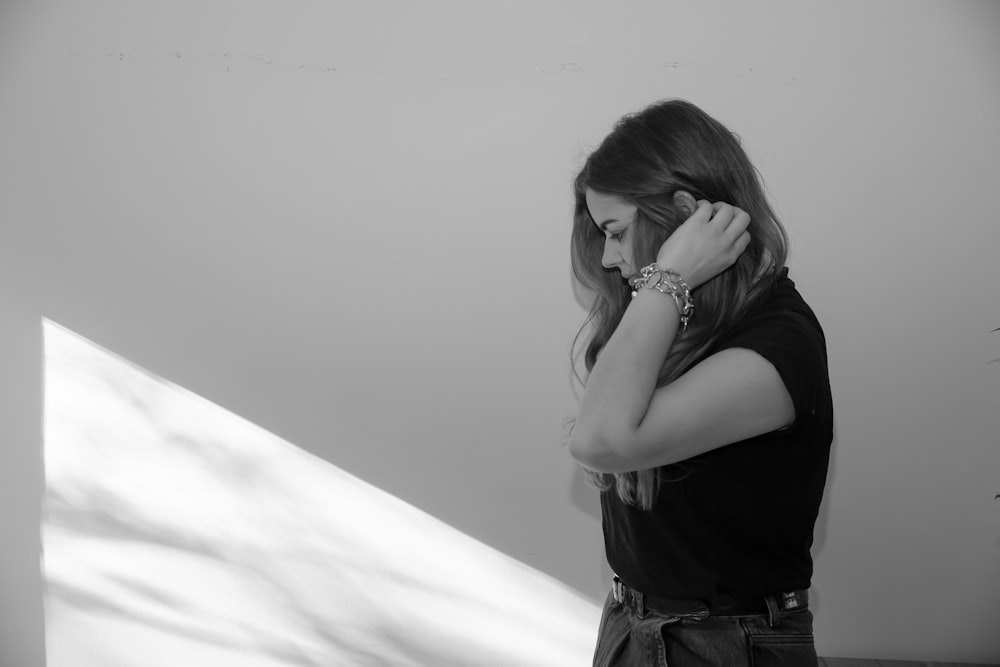 woman in black shirt covering her face with her hair