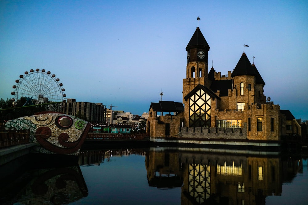 brown and black concrete building near body of water during night time