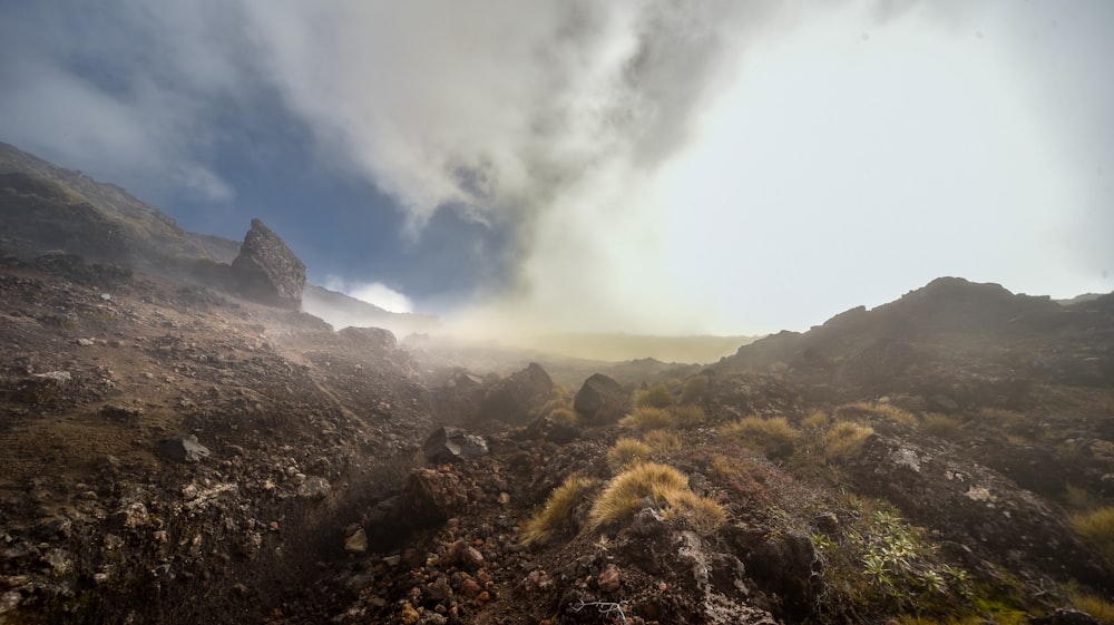 brown and green mountain under white clouds during daytime